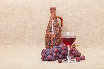 Image showing Art composition from clay bottle, grapes and glass