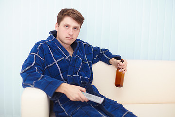 Image showing Person has a rest in a dressing gown on sofa