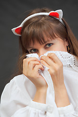 Image showing Young sexy woman coquettishly hides face behind a lacy collar