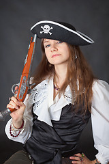 Image showing Portrait of beautiful girl in pirate hat with pistol in hand