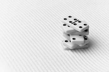 Image showing Dominoes against sand