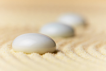 Image showing Glass drops on sand surface