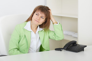 Image showing Woman it is puzzled scratches in nape thinking of something