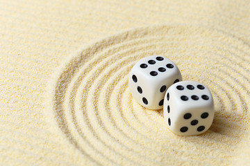 Image showing Dices on sand surface - abstract art composition