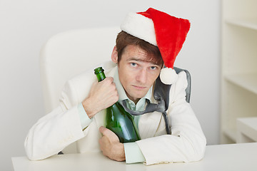 Image showing Young drunkard celebrates new year at office