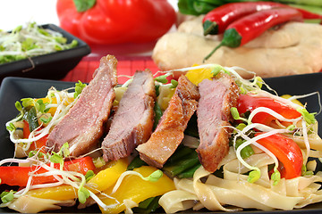 Image showing Duck breast with fried noodles