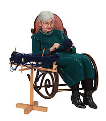 Image showing Old woman using a reel