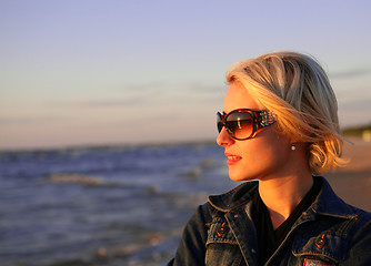 Image showing young blond woman looking at sunset