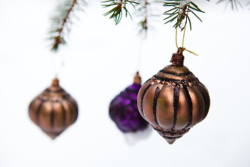 Image showing Christmas baubles on a snowy pine