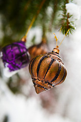 Image showing Christmas baubles on a snowy pine