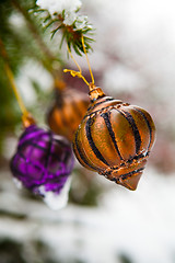 Image showing Christmas baubles on a snowy pine