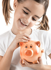 Image showing Little girl with a piggy-bank