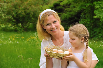 Image showing Mother and daughter holding fresh eggs