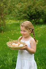 Image showing Little girl holding fresh eggs