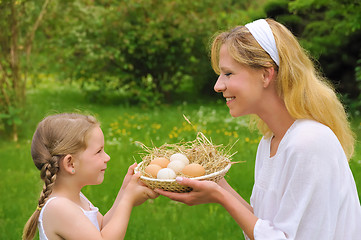 Image showing Mother and daughter holding fresh eggs