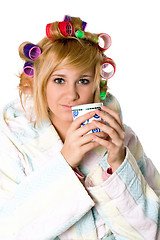 Image showing funny housewife with curlers and cup 