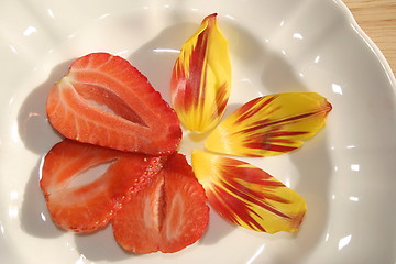 Image showing strawberry slices and petals