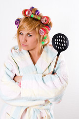 Image showing housewife with curlers and skimmer
