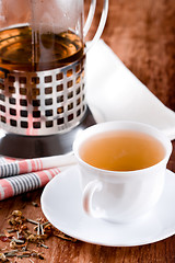 Image showing french press and cup of fresh herbal tea 