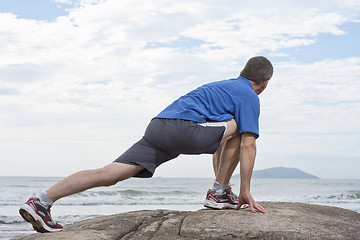 Image showing Runner doing stretching exercise