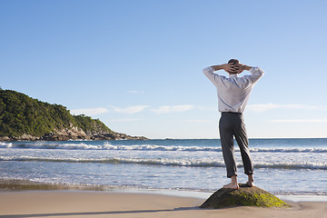 Image showing Businessman relaxing on a beach