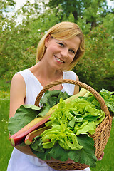 Image showing Young woman holding basket with vegetable