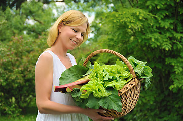 Image showing Young woman holding basket with vegetable
