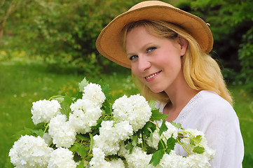 Image showing Young woman with snowballs