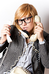 Image showing businesswoman with three phones 