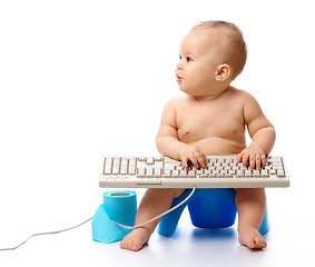 Image showing Little child is typing on keyboard