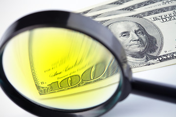 Image showing Dollars under a magnifying glass