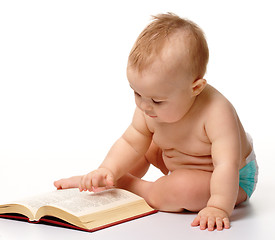 Image showing Little child play with book