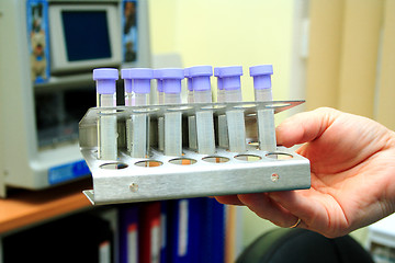 Image showing hand holding test tubes