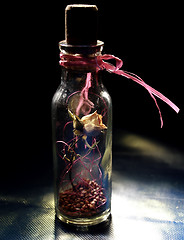 Image showing dried yellow rose in the bottle