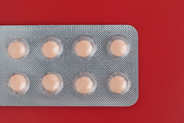 Image showing Close-up of a pack of orange pills 