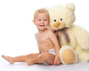 Image showing Happy child with big soft bear toy