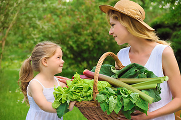 Image showing Young woman and daughter with fresh vegetable