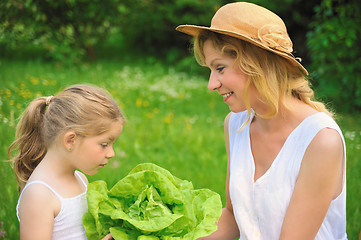 Image showing Young mother and daughter with lettuce