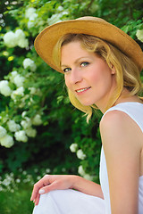 Image showing Young woman resting in garden