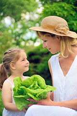 Image showing Young mother and daughter with lettuce