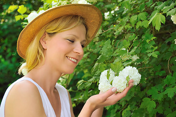 Image showing Young woman gardening - taking care of snowball