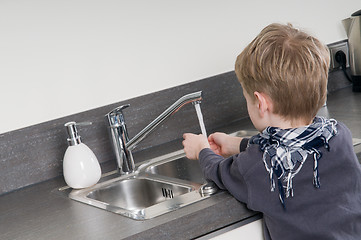 Image showing Child washing his hands