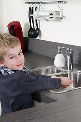 Image showing Child washing his hands