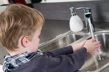 Image showing Child washing his hands