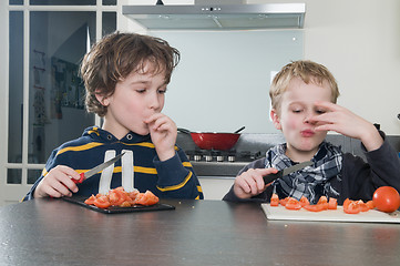 Image showing Boys tasting tomato