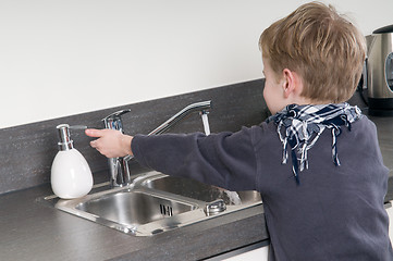 Image showing Child washing his hands