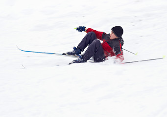 Image showing Boy Skier fell on snow