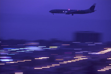 Image showing A jet approaches the runway at night for landing at the Los Angeles International Airport, USA.Panned shot.