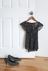 Image showing Polka dot shoes and stylish blouse on a hanger