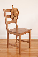 Image showing Cowboy hat on a wooden chair